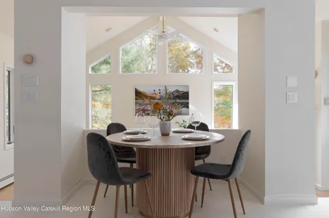 a dining room with furniture and window