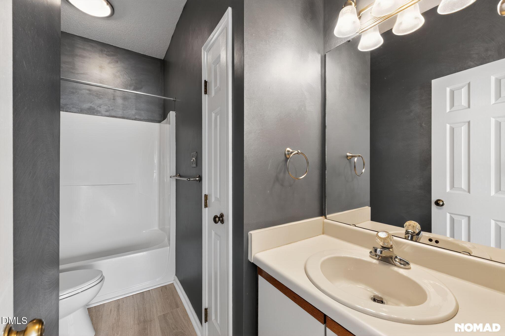 4456 Still Pines Drive Raleigh, NC 27613 - Photo 11 of 16 a bathroom with a sink a toilet and shower