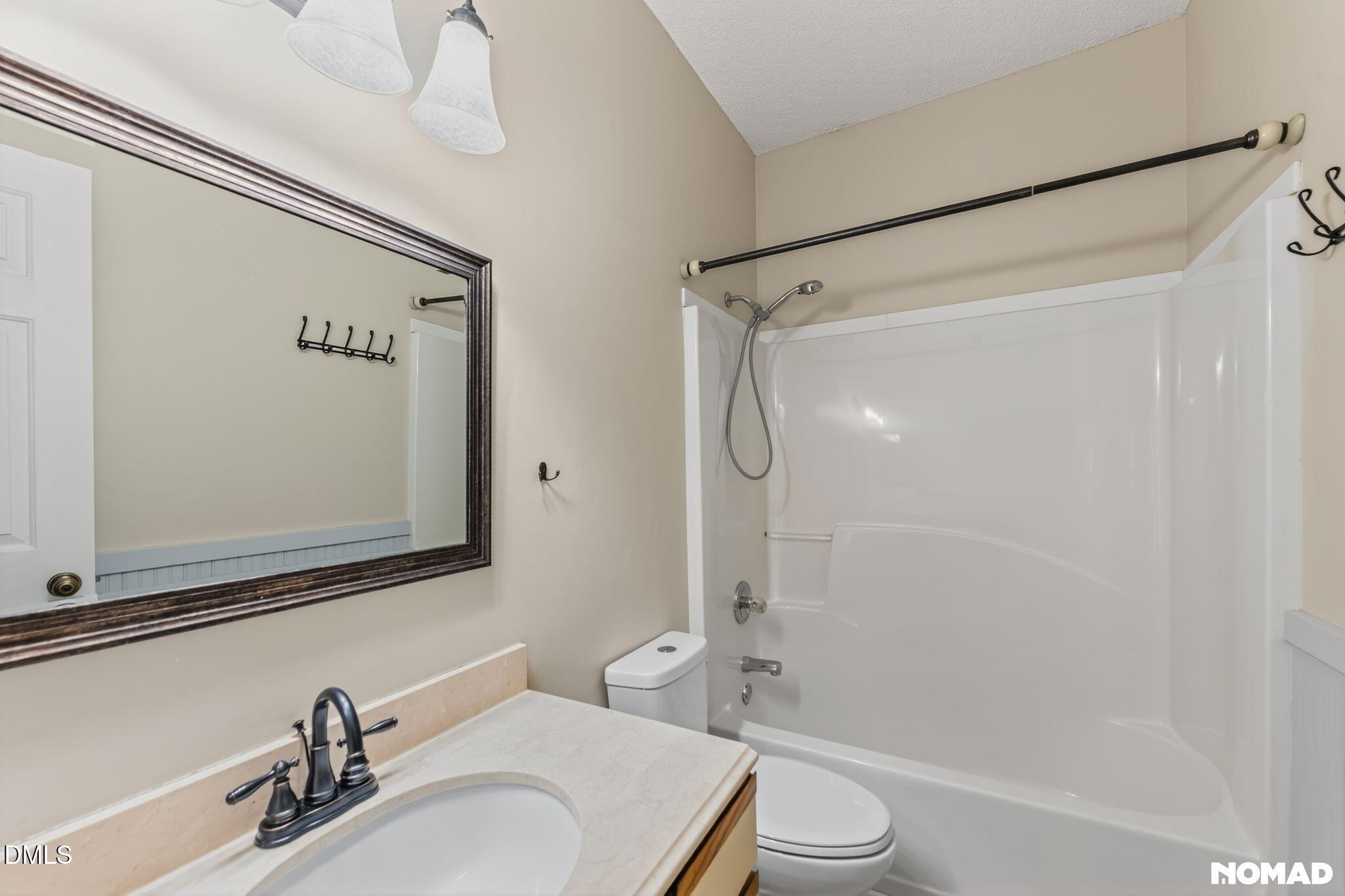 4456 Still Pines Drive Raleigh, NC 27613 - Photo 13 of 16 a bathroom with a sink a toilet and shower