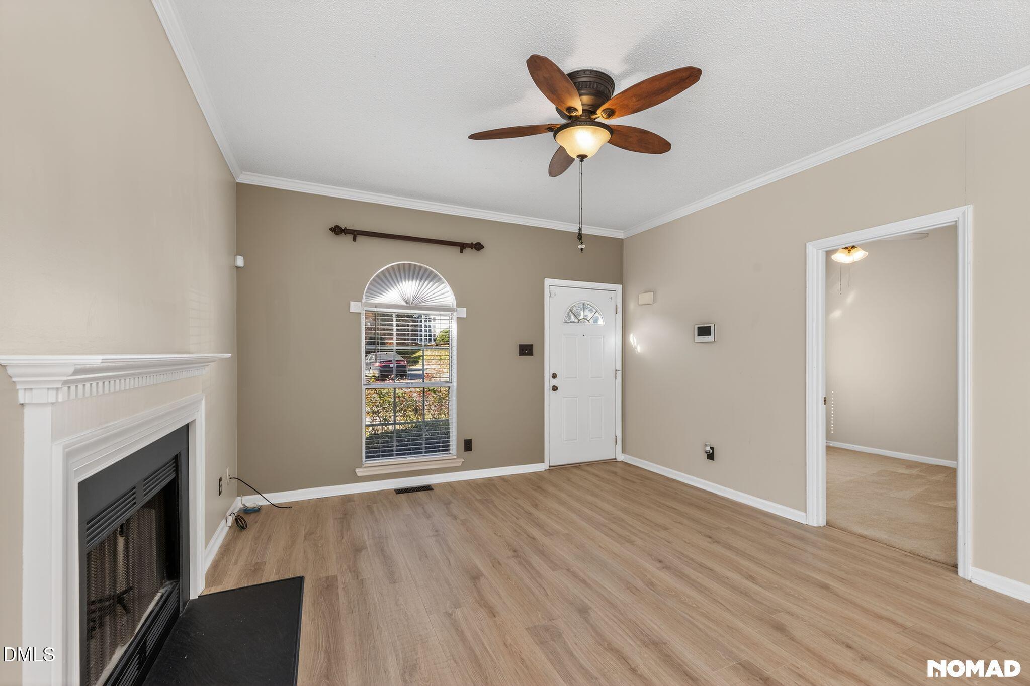 4456 Still Pines Drive Raleigh, NC 27613 - Photo 3 of 16 wooden floor in an empty room with a fireplace