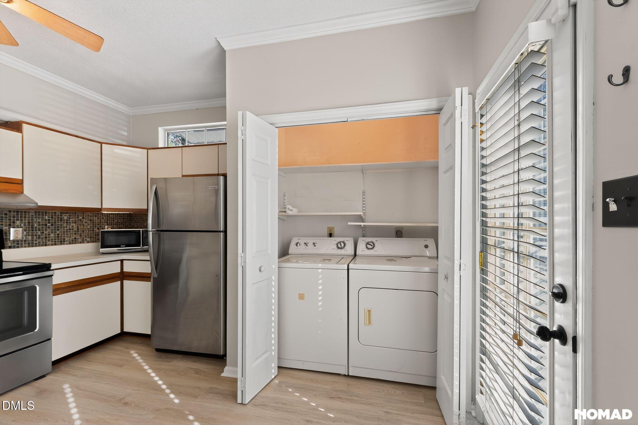 4456 Still Pines Drive Raleigh, NC 27613 - Photo 6 of 16 a kitchen with a refrigerator sink and cabinets
