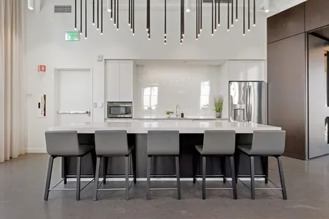 a dining table with chairs and cabinets