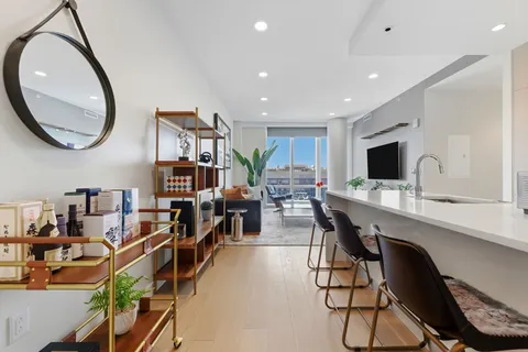 a view of a livingroom with furniture and a flat screen tv