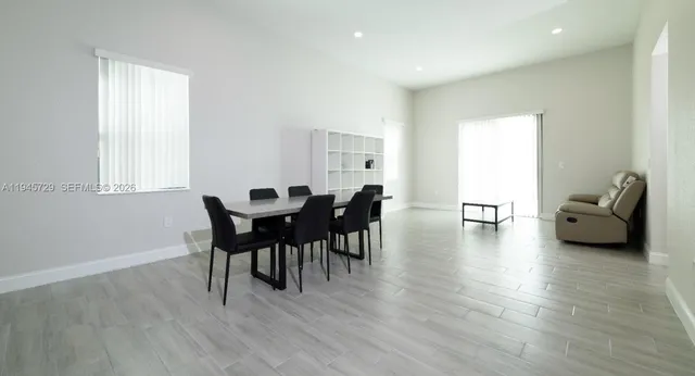 a work room with furniture wooden floor and a window