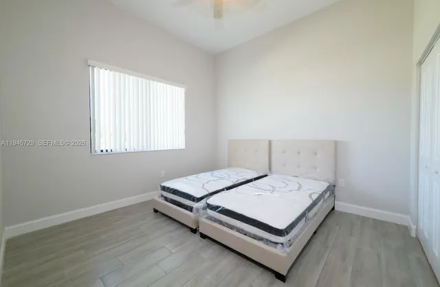 a bedroom with two beds and a chandelier