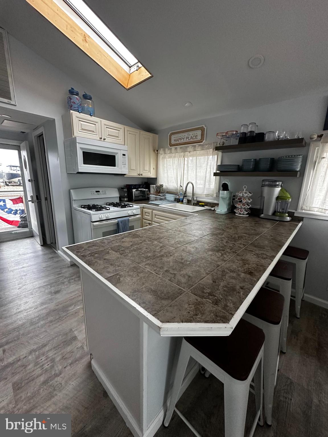 24 Angler Road Tuckerton, NJ 08087 - Photo 11 of 27 a kitchen with stainless steel appliances granite countertop a sink a stove and a microwave