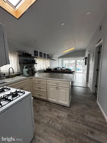 a kitchen with stainless steel appliances granite countertop a stove and a sink