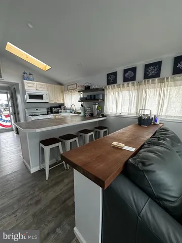 a kitchen with kitchen island a sink table and chairs
