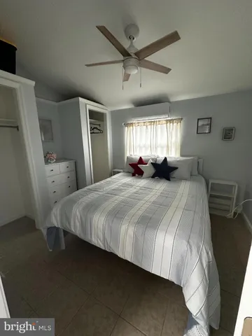 a large bed sitting in a room next to a window