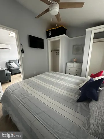 a bedroom with a bed and a mirror