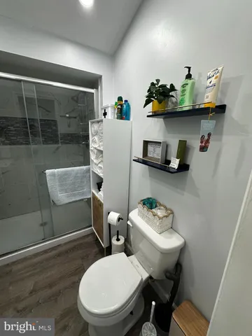 a bathroom with a toilet a sink and a shower