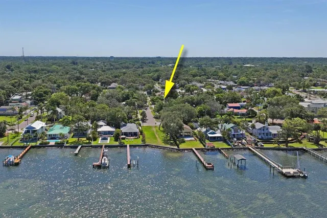 an aerial view of a houses with a swimming pool