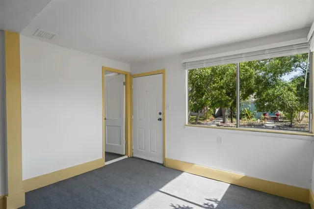 a view of a livingroom with wooden floor and a ceiling fan