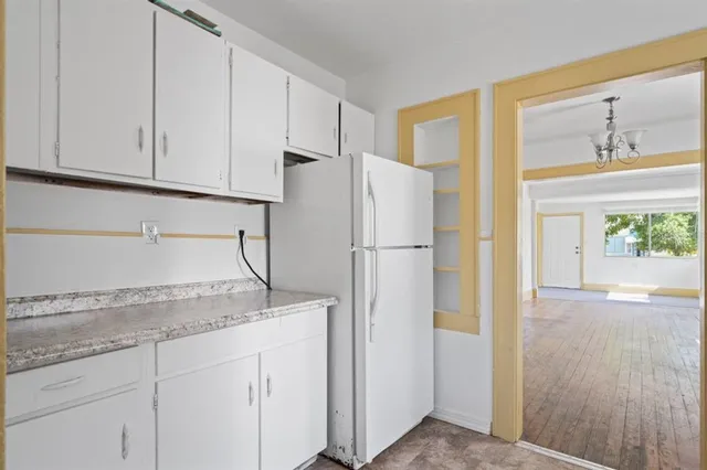 a kitchen with granite countertop cabinets and refrigerator
