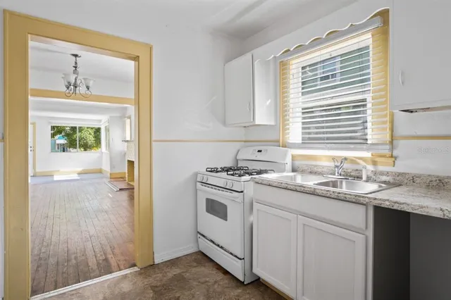 a kitchen with a sink stove and cabinets