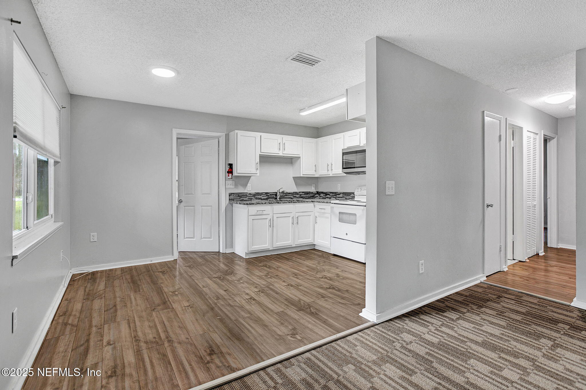 3645 Edison Avenue Jacksonville, FL 32254 - Photo 6 of 19 a kitchen with granite countertop a stove and a refrigerator
