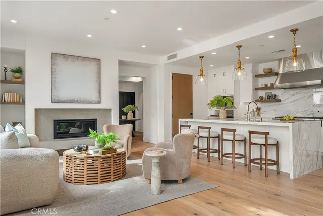 a living room with furniture a fireplace and a table