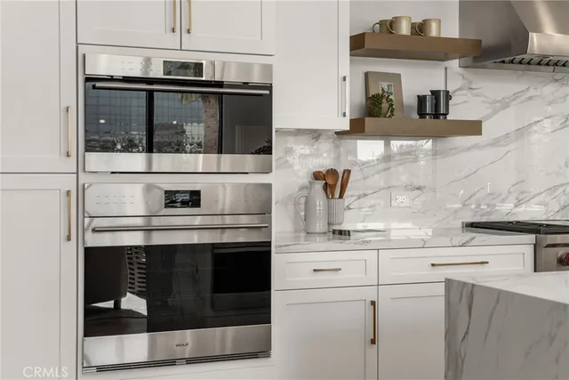 a kitchen with stainless steel appliances granite countertop a stove and a microwave
