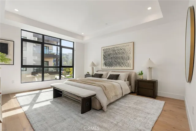 a spacious bedroom with a bed and a large window