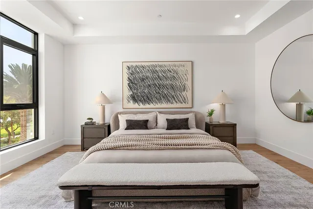 a bed sitting in a bedroom next to a window