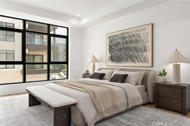 a bedroom with a bed and a painting on the wall