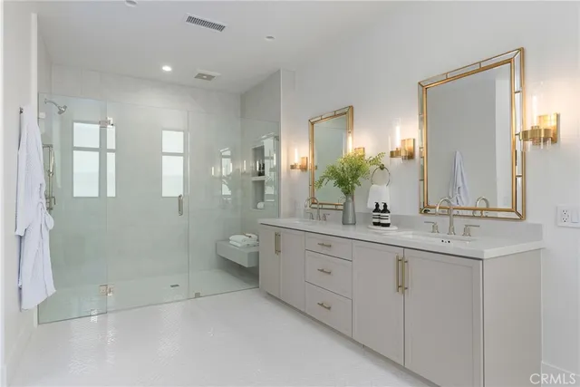 a spacious bathroom with double sink and shower