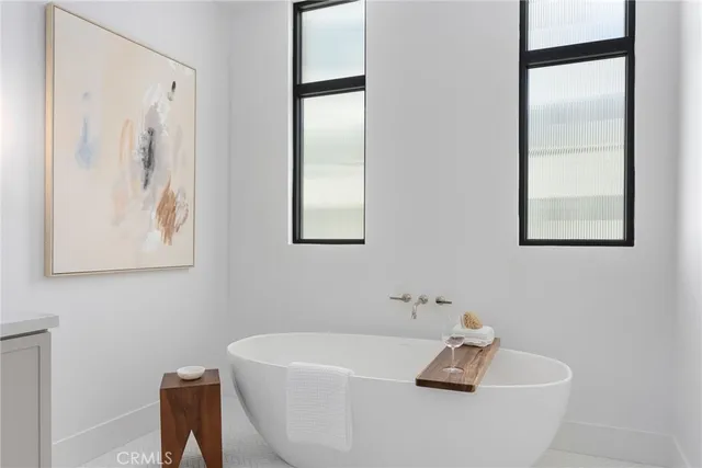 a white bath tub sitting next to a white sink