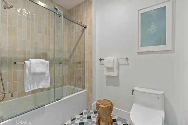 a bathroom with a toilet and a bathtub