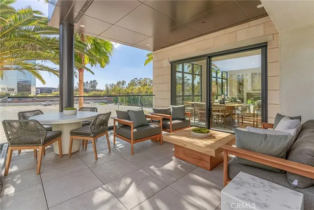a living room with patio furniture and a floor to ceiling window