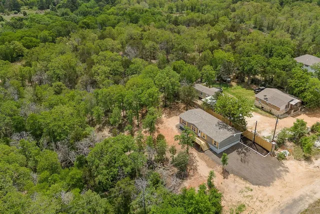 an aerial view of a house with yard