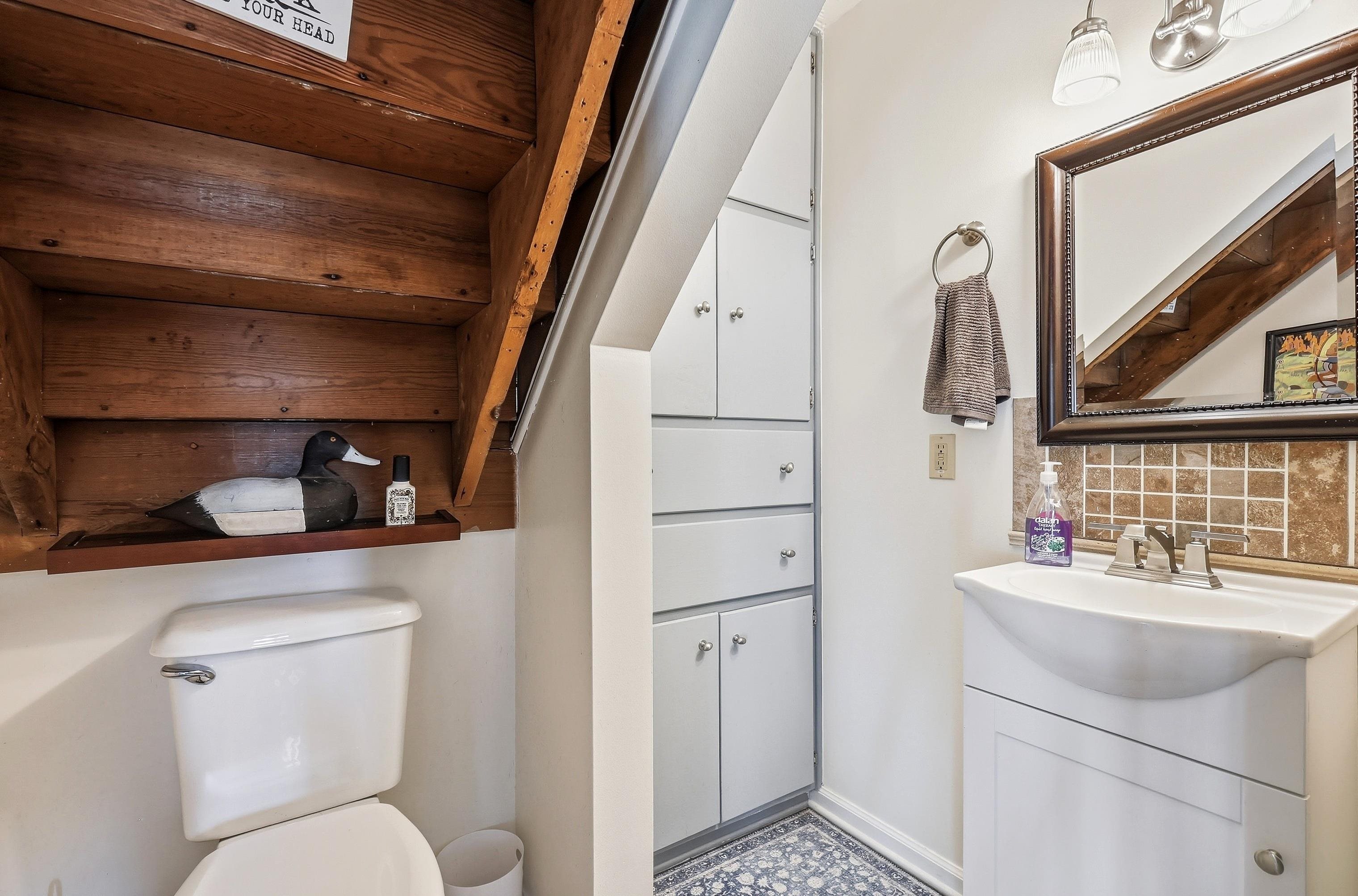 2181 South Irish Hollow Road Galena, IL 61036 - Photo 27 of 48 a bathroom with a toilet sink and mirror