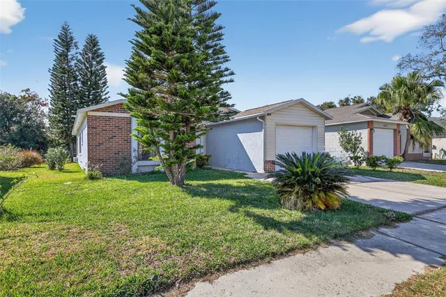 a front view of a house with a garden and yard