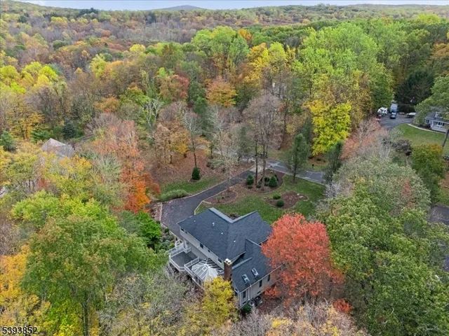 an aerial view of a house with yard