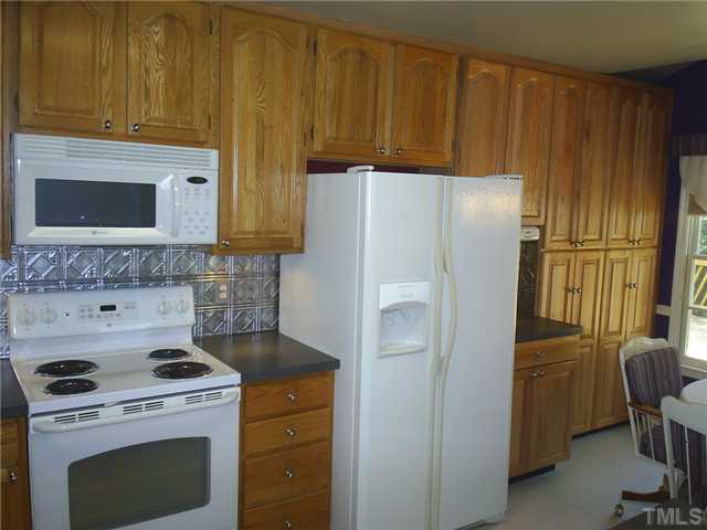 6909 Whittlesea Place Raleigh, NC 27616 - Photo 3 of 16 Got Cabinets? We do! Plenty O' Plenty of space for the fancy dishes or the big eaters! Cabinets have roll out shelving! There are more they just don't fit in one picture!