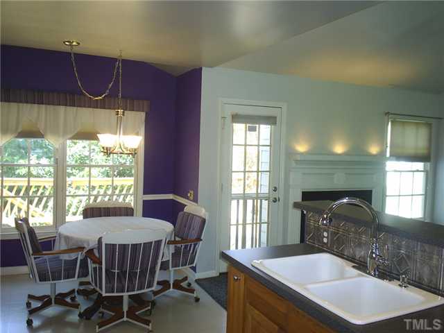 6909 Whittlesea Place Raleigh, NC 27616 - Photo 5 of 16 Such a great setting for eating dinner, your choice of window view or fireplace! Open plan allows for a spacious room!