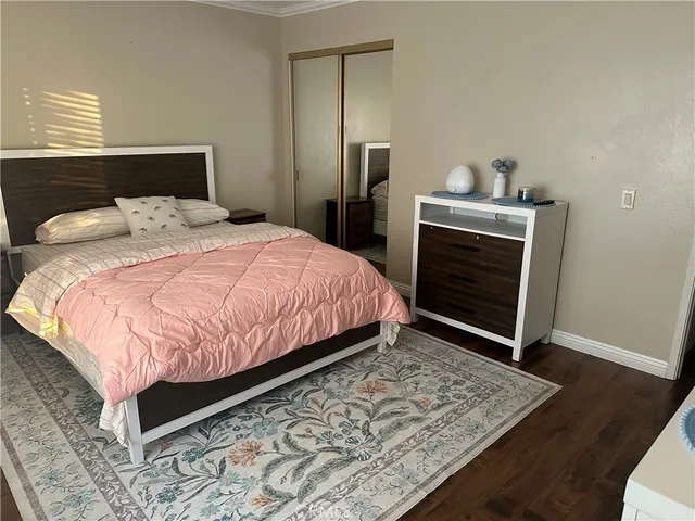 a bedroom with a bed and dresser