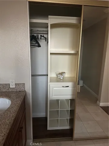 a bathroom with a granite countertop sink and washing machine