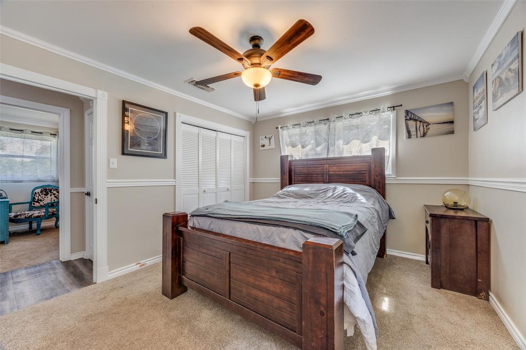 9591 Dripping Spring Road Denison, TX 75021 - Photo 11 of 23 a bedroom with a bed and a ceiling fan