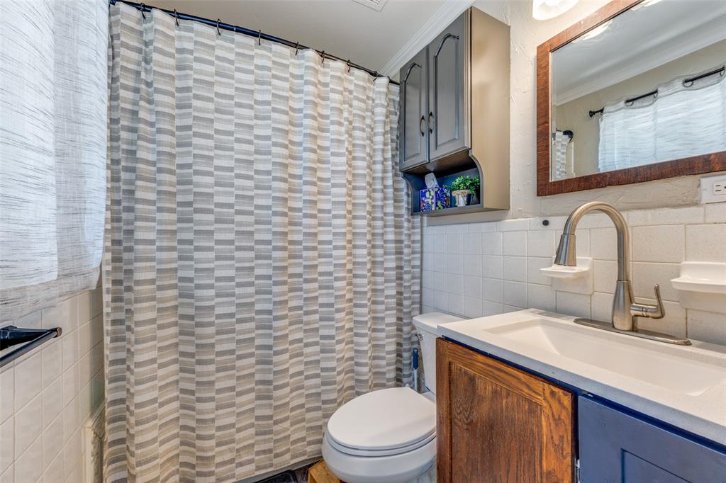 9591 Dripping Spring Road Denison, TX 75021 - Photo 12 of 23 a bathroom with a toilet sink and mirror