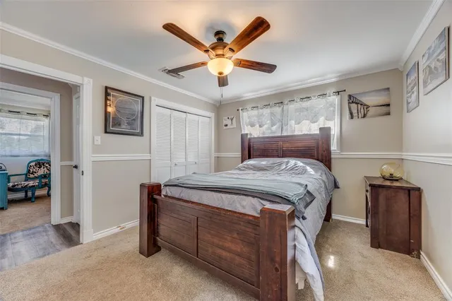 a bedroom with a bed and a ceiling fan