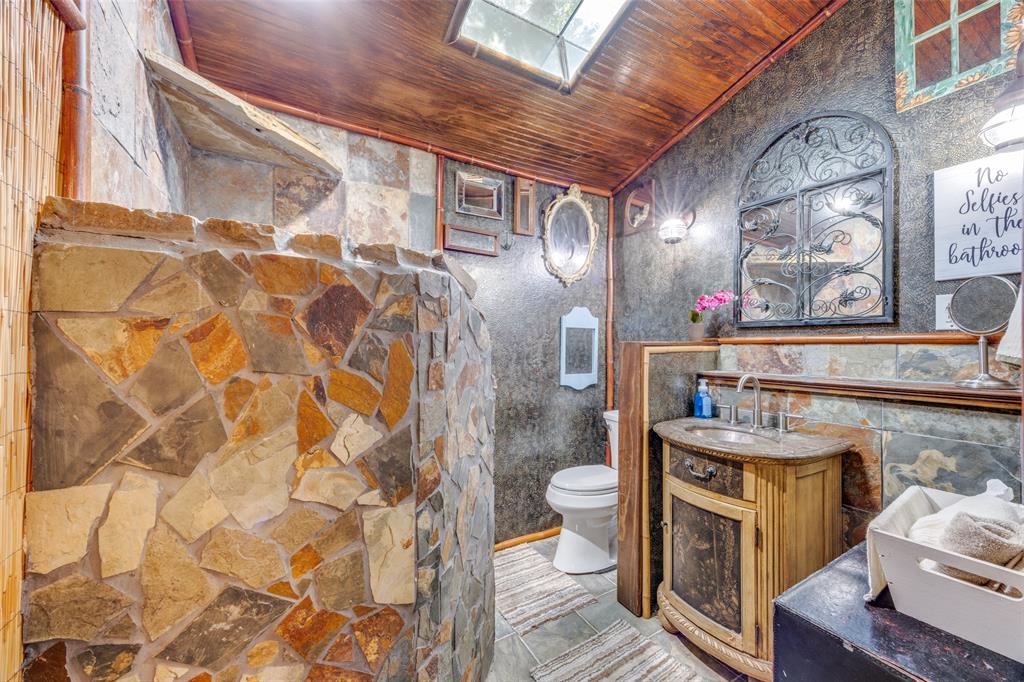 9591 Dripping Spring Road Denison, TX 75021 - Photo 18 of 23 a bathroom with a sink and mirror