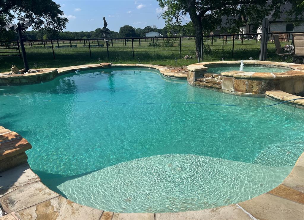 9591 Dripping Spring Road Denison, TX 75021 - Photo 2 of 23 a view of a swimming pool with a lake