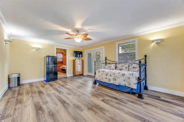 a bedroom with a large bed and a chandelier