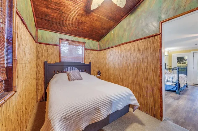 a bedroom with a bed and a mirror