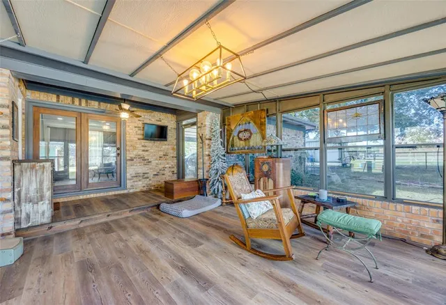 a sitting area with furniture and wooden floor