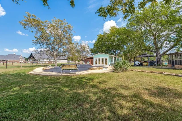 a front view of a house with swimming pool having outdoor seating