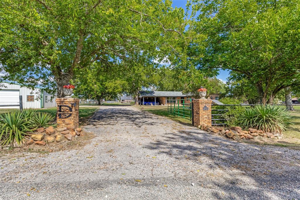 9591 Dripping Spring Road Denison, TX 75021 - Photo 4 of 23 a front view of a house with a yard