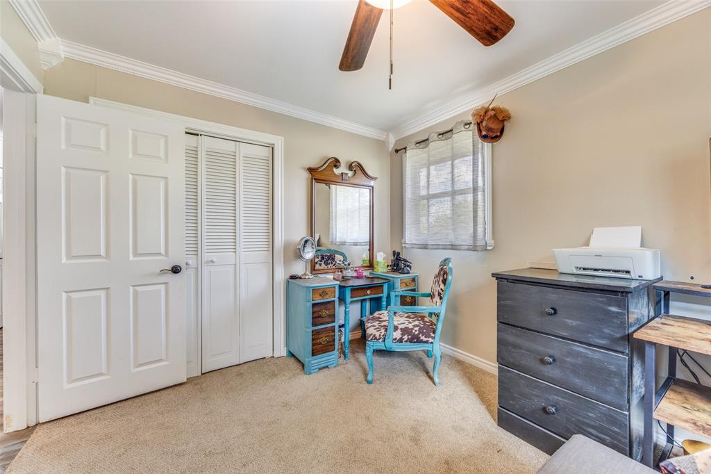 9591 Dripping Spring Road Denison, TX 75021 - Photo 9 of 23 a room that has a dresser and a chair in it