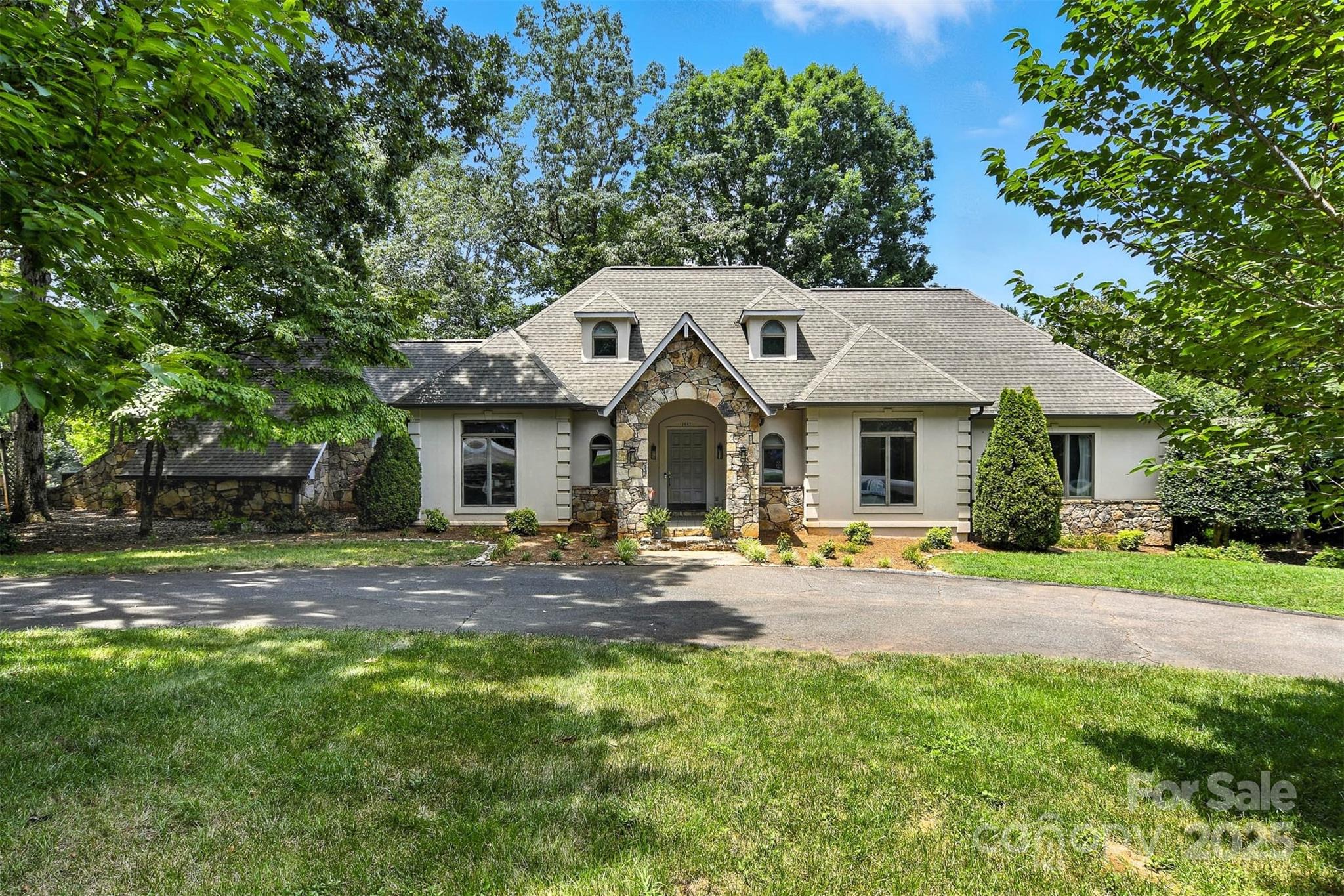 a view of a house with garden and trees