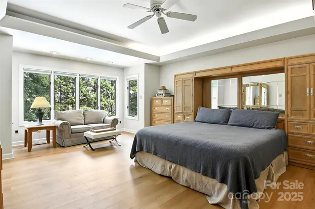 a bedroom with a bed and glass walk in closet